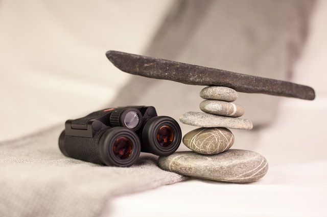 Binoculars and balanced stone stack
