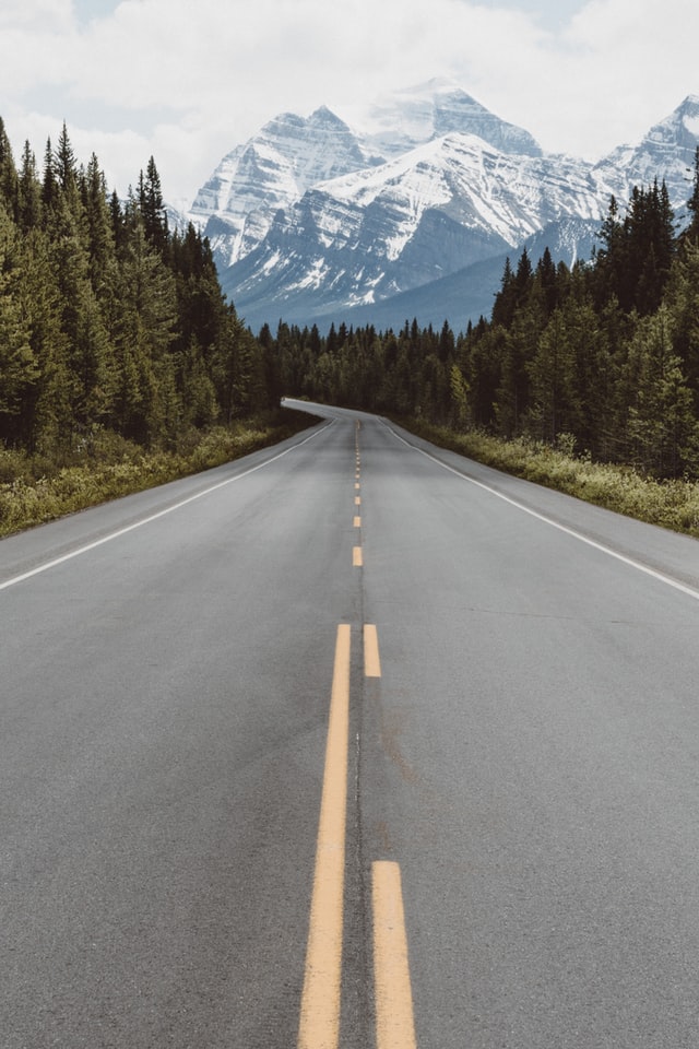 Road toward a snow capped mountain