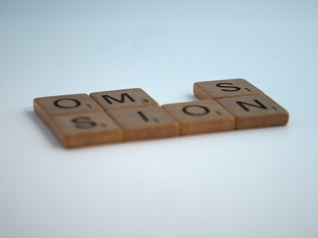 scrabble tiles spelling omission with missing letter