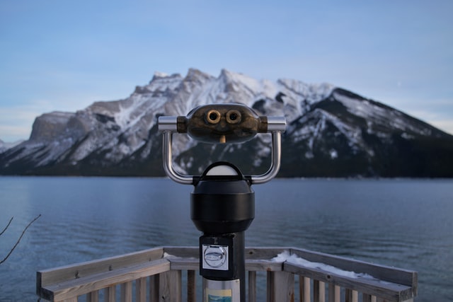 Binoculars viewing mountain across water