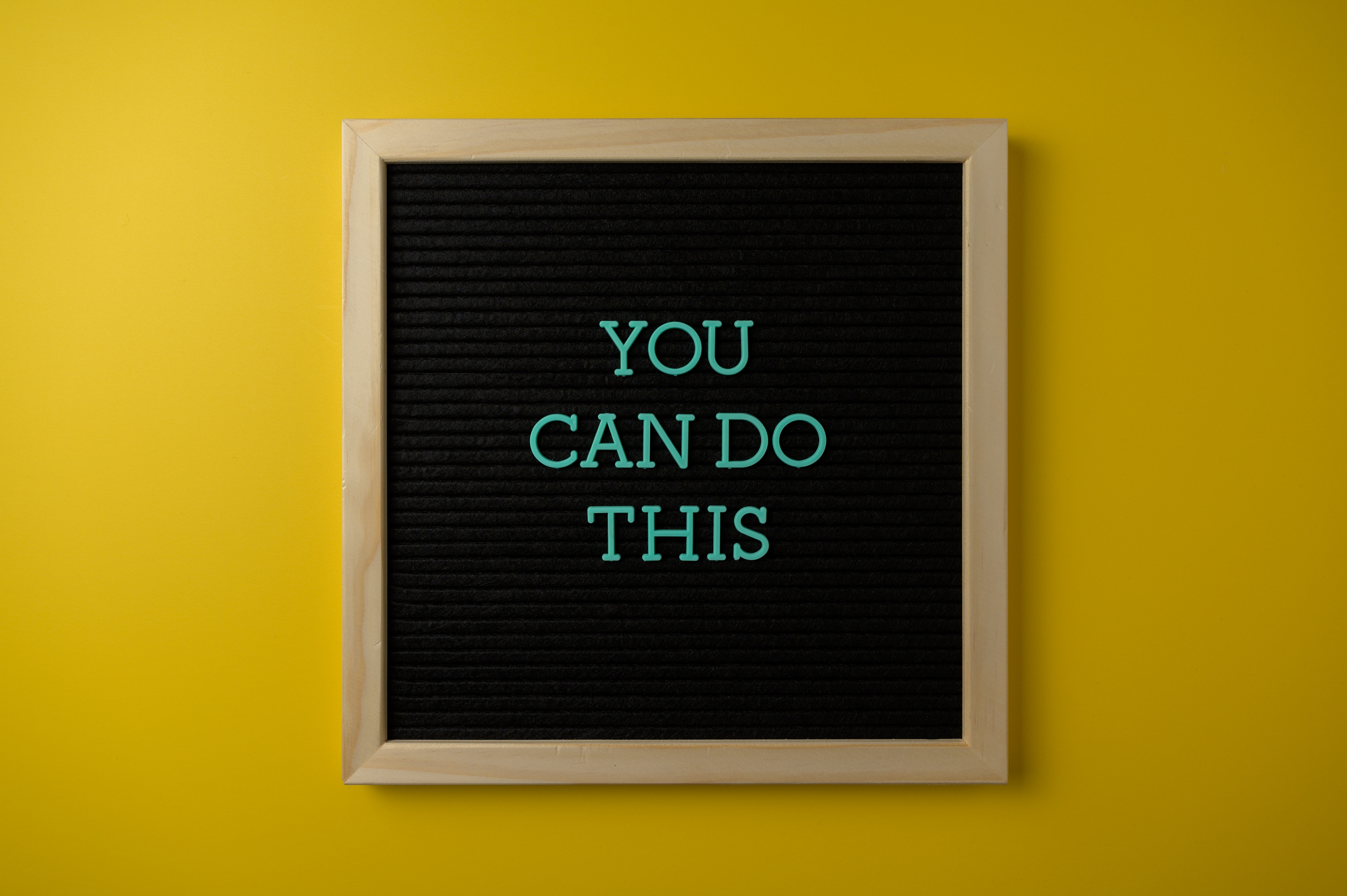  A sign reading "You can do this" on a yellow background 